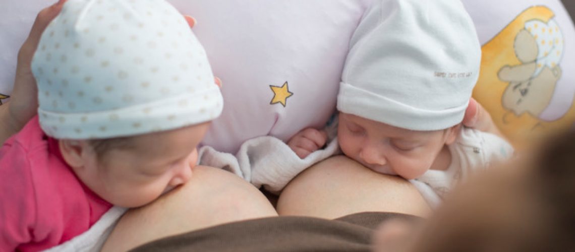 Breastfeeding twin babies with pillow device for feeding at home